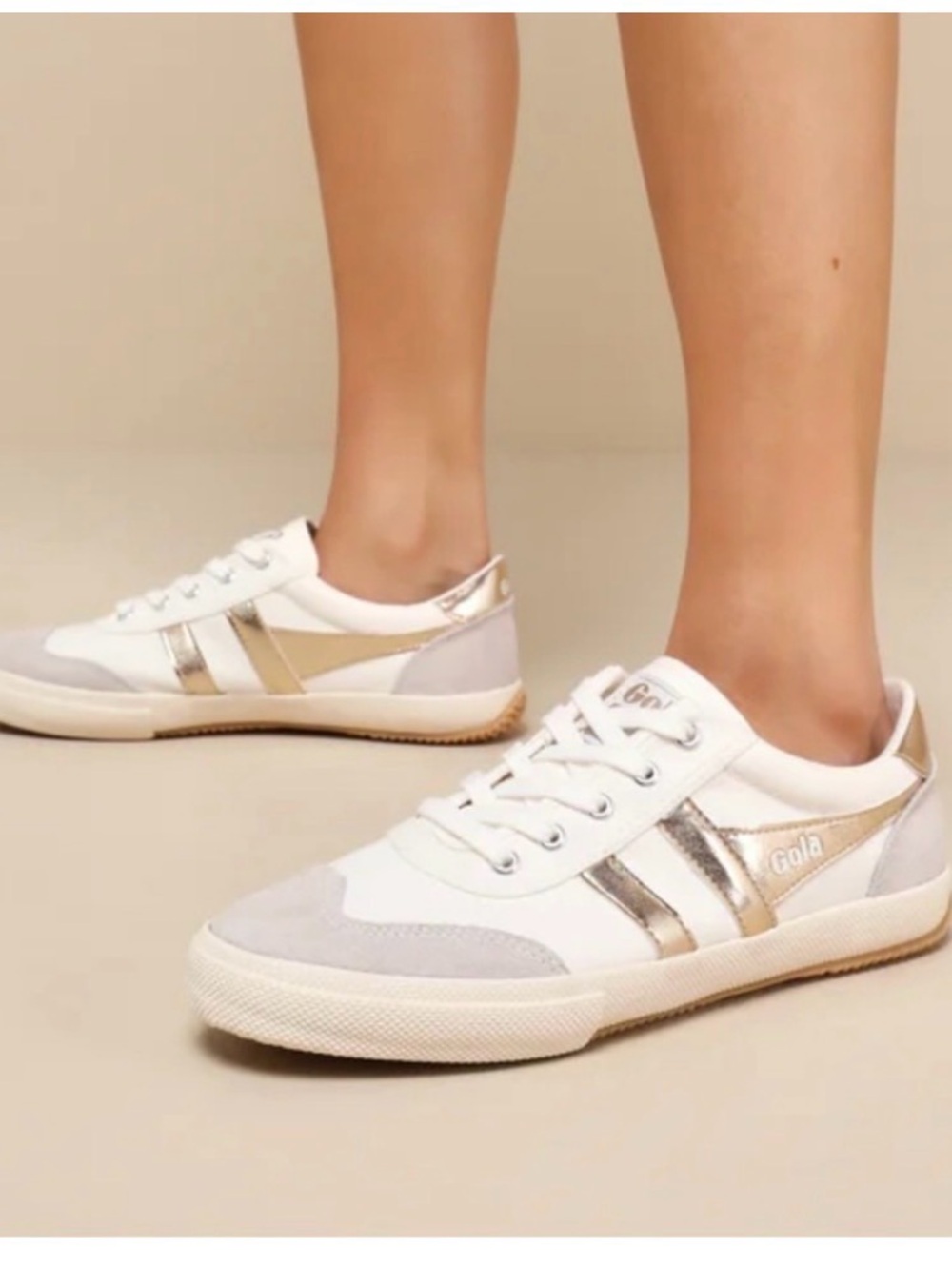 Gola Badminton plimsoll sneaker in the white and gold colorway.
Anthropologie